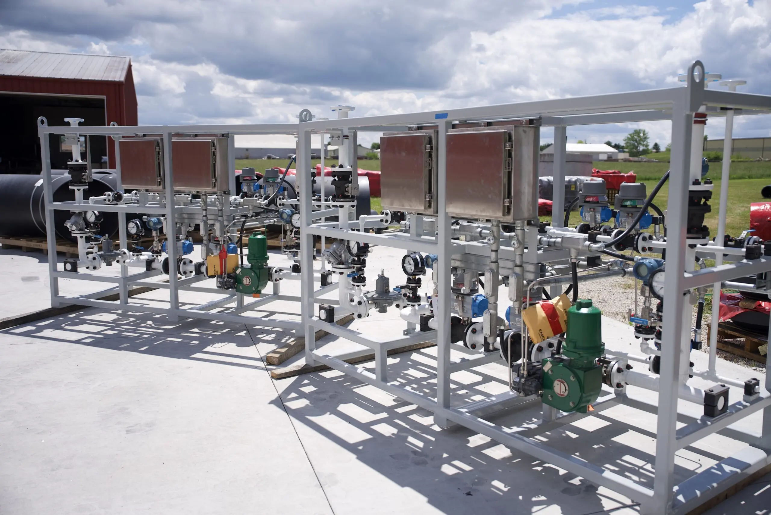 Skid-mounted piping and process equipment assembly for an industrial facility