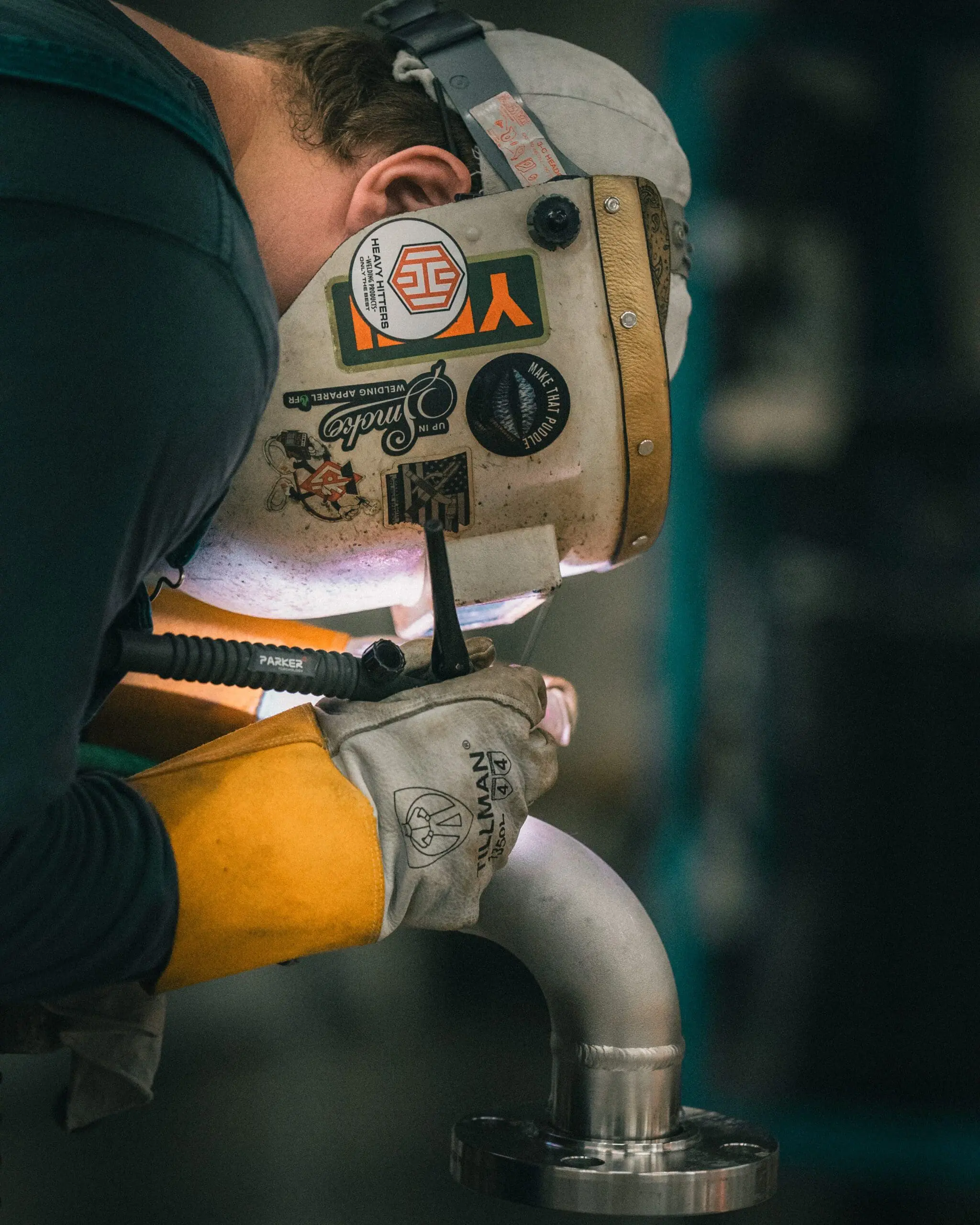 Welder fabricating a stainless pipe elbow for an industrial piping tie-in
