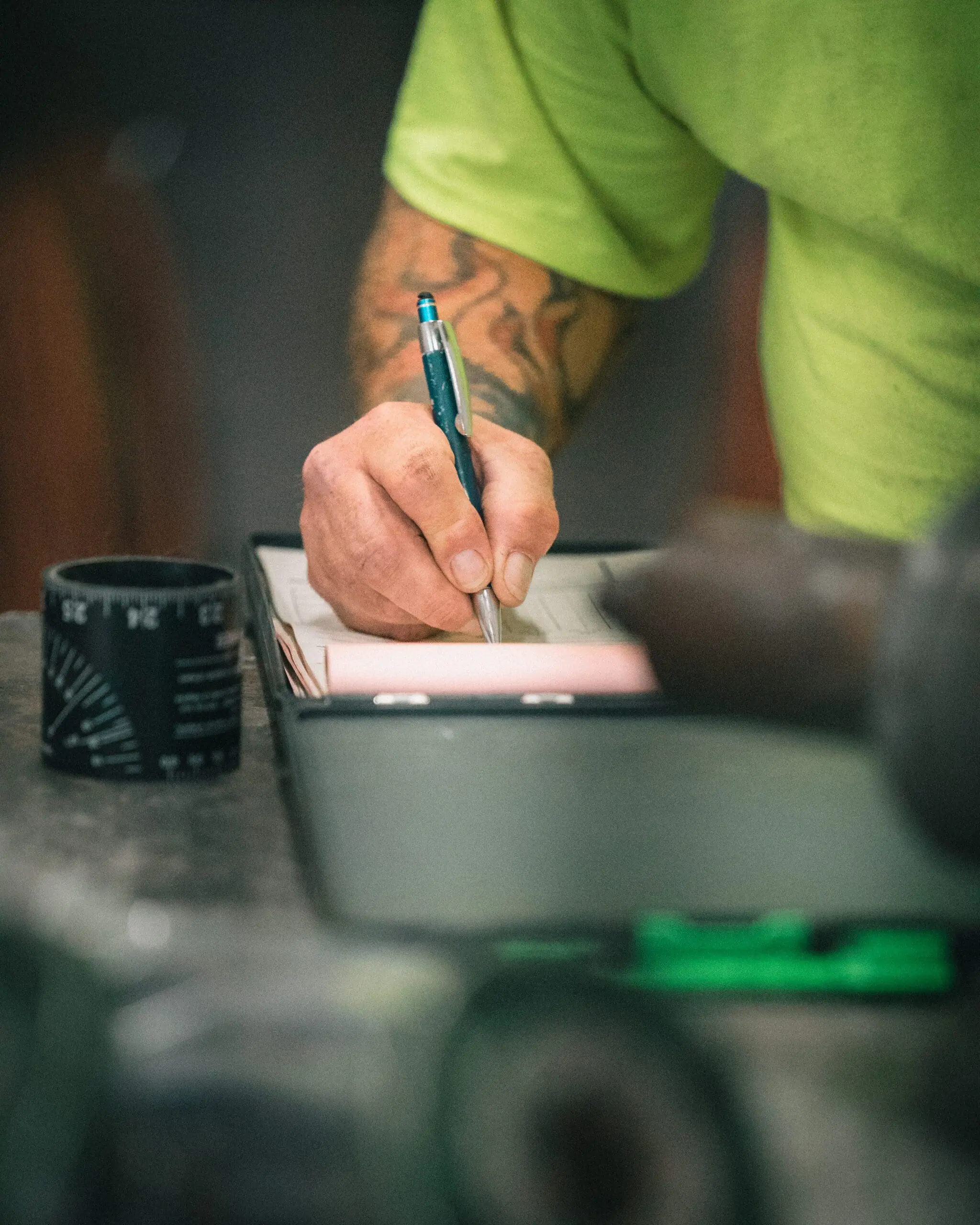 Technician recording field notes during an industrial piping inspection