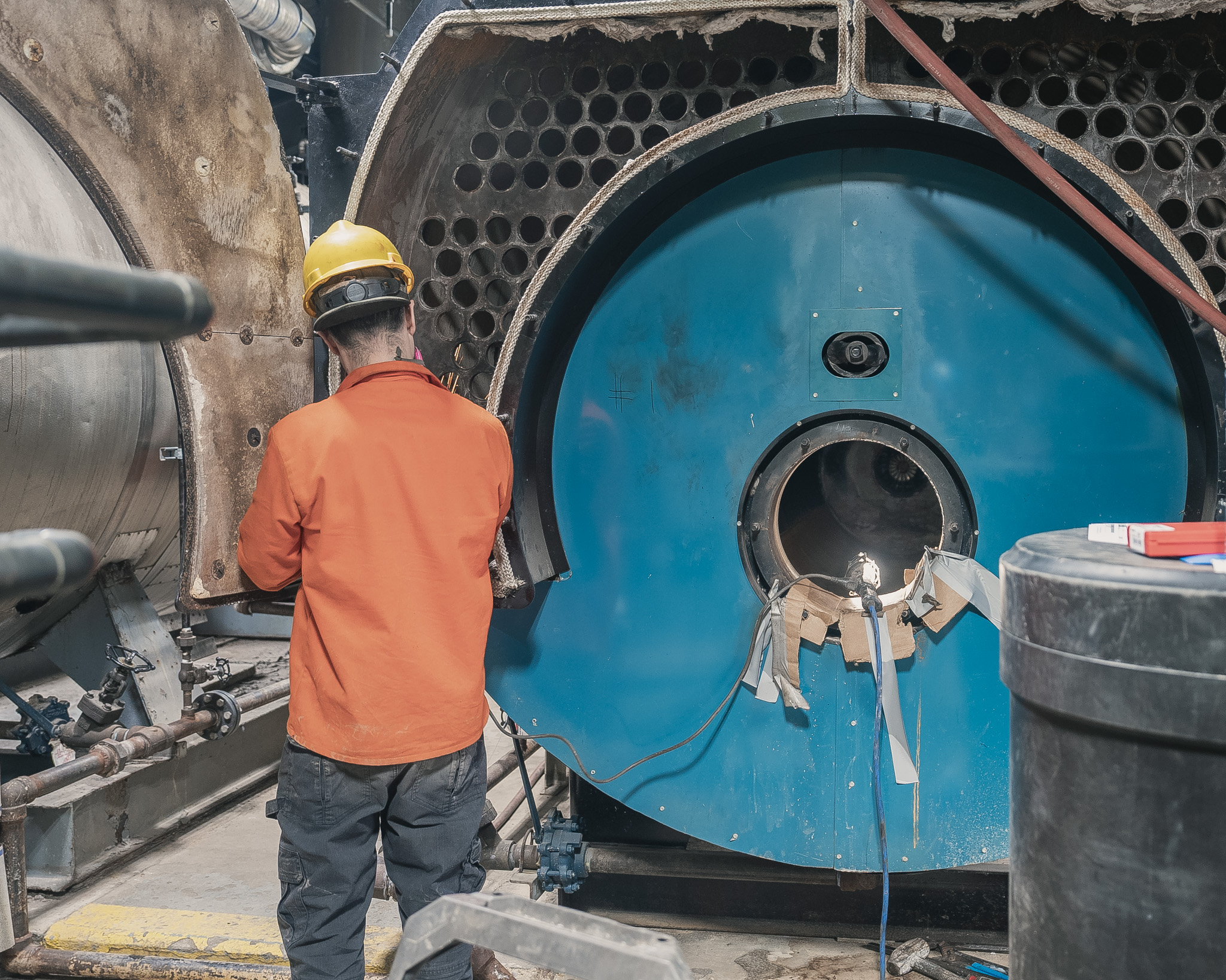 Technician inspecting industrial boiler equipment