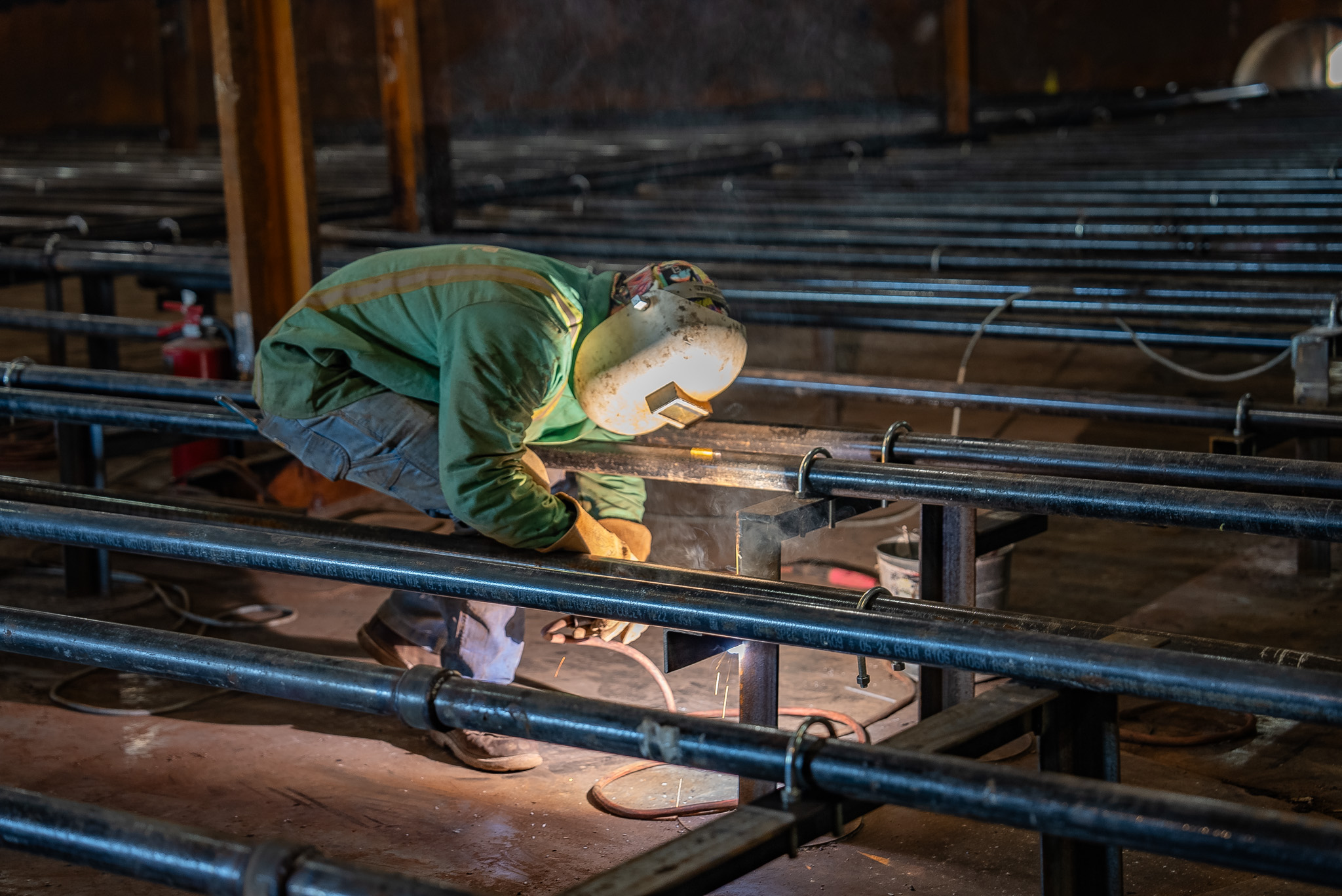 ASME‑certified pipfitter from DePue Mechanical installing industrial process piping at an industrial job site in Illinois.
