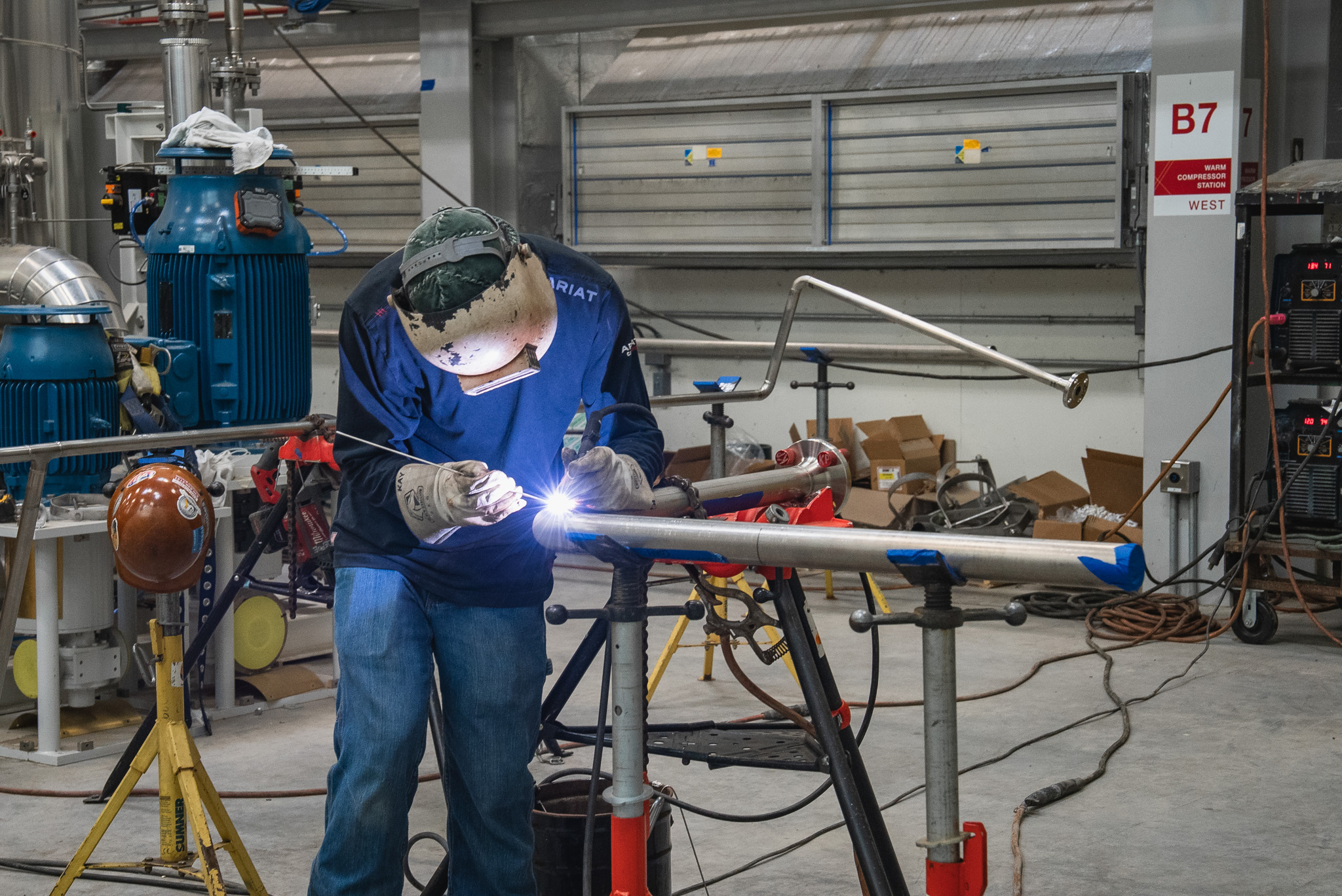 Industrial pipe welding on carbon steel piping inside a plant